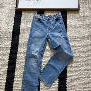 Levi high-rise, distressed, straight-leg jeans with a button fly raw hem